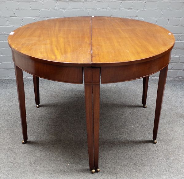 A George III mahogany D-end extending dining table on tapering square supports, three extra leaves, 115cm wide x 112cm long x 257cm long extended.