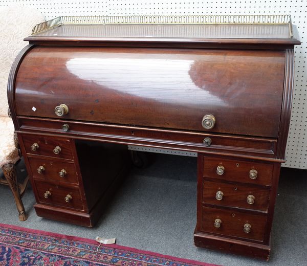 A 19th century mahogany roll top desk with fitted interior and six pedestal drawers, 136cm wide x 110cm high.