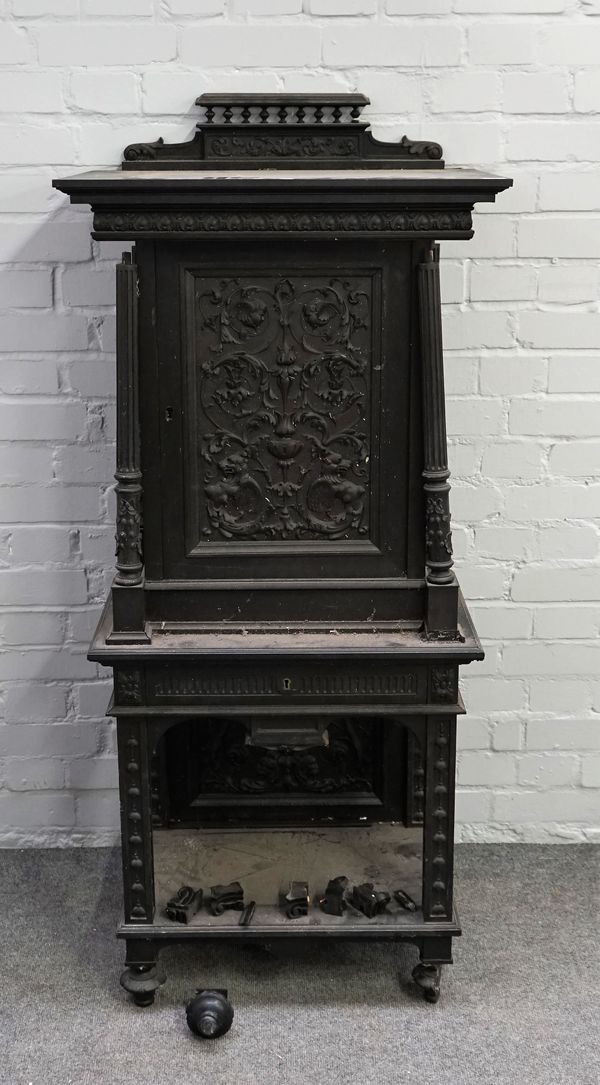 A 19th century Dutch ebony and ebonised carved side cabinet with carved panel door over drawer united by platform undertier, 63cm wide x 131cm high. 1