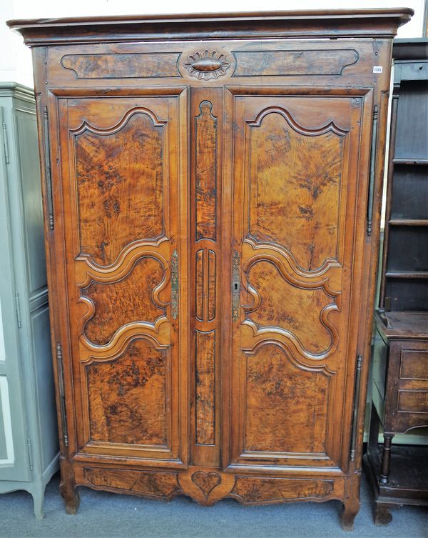 An 18th century Continental fruitwood and elm armoire, with pair of doors with three shaped panels, on square cabriole supports, 149cm wide x 210cm hi