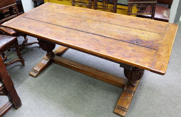 A 17th century style oak refectory table, the cleated plank top on carved bulbous supports, united by 'H' frame stretcher, 85cm wide x 184cm long.