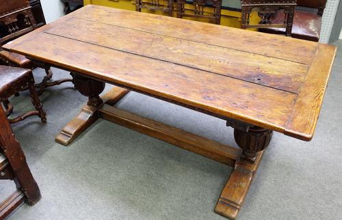 A 17th century style oak refectory table, the cleated plank top on carved bulbous supports, united by 'H' frame stretcher, 85cm wide x 184cm long.