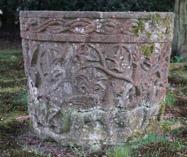 A carved red Verona stone wellhead, Italian, 17th century, with meandering border and decoration, 70cms high, 90cms wide.