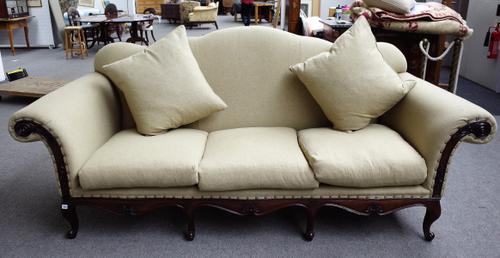 Ralph Lauren; a Louis XV style hump back sofa with carved hardwood frieze on scroll supports, 262cm wide x 115cm high.