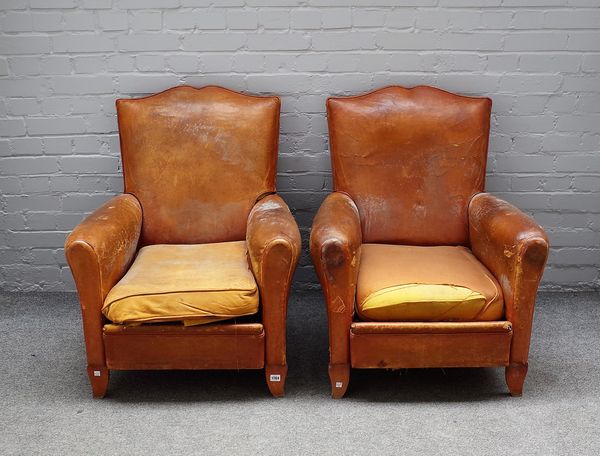 A pair of 20th century French leather upholstered club chairs on shaped beech supports, 73cm wide x 88cm high. (2)