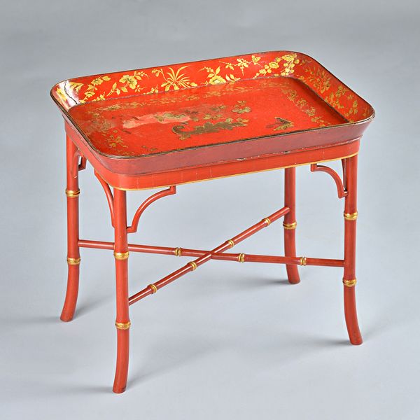 A papier-mâché oval tray on stand, decorated with a faux tortoiseshell design on wood stand and square tapering legs, 60cms wide, 66cms high; and a Re