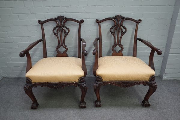 A pair of 18th century style mahogany framed open armchairs with pierced splat back on acanthus carved cabriole supports and claw and ball feet, 70cm