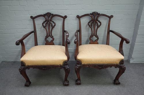 A pair of 18th century style mahogany framed open armchairs with pierced splat back on acanthus carved cabriole supports and claw and ball feet, 70cm