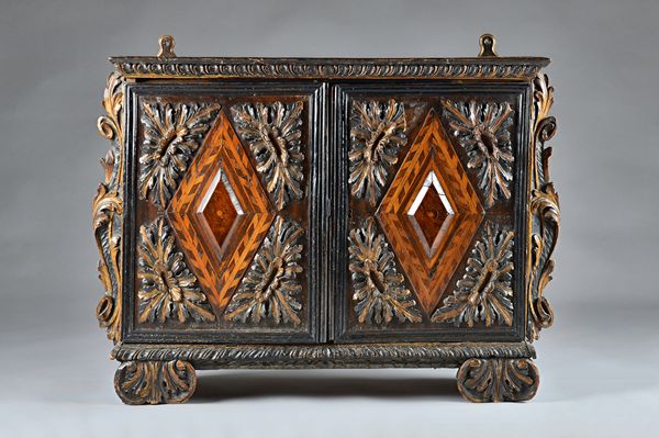 A 17th century Italian or South German parquetry table top cabinet, with pair of parcel gilt ebonised doors inset with walnut and birch diamond panels