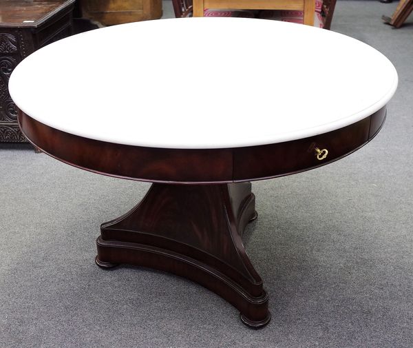 Ralph Lauren; an early 19th century style gueridon/ centre table, the circular marble top on flared mahogany triangular base with a pair of frieze dra