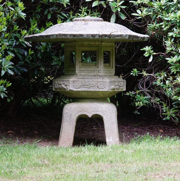 A Japanese carved stone hexagonal garden lantern, 20th century, 126cms high.