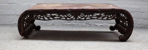 A late 19th century Chinese carved hardwood low table 101cm wide x 31cm high together with a nest of three occasional tables, (a.f.).  (4) 1899