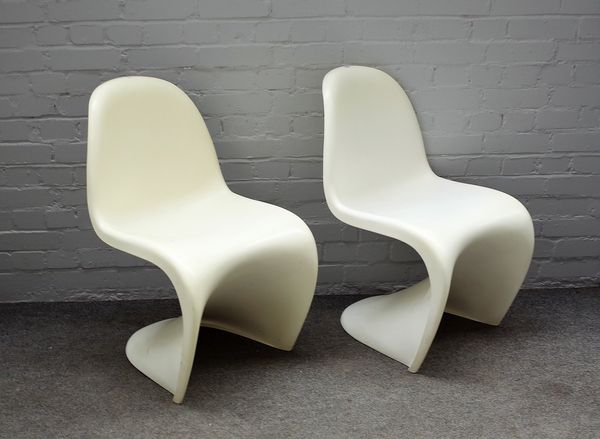 Probably Verner Panton, two one piece moulded, white plastic chairs, 49cm wide x 83cm high.