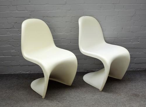 Probably Verner Panton, two one piece moulded, white plastic chairs, 49cm wide x 83cm high.