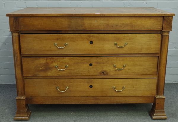 A 19th century fruitwood commode of four long drawers flanked by turned columns, 131cm wide x 93cm high.