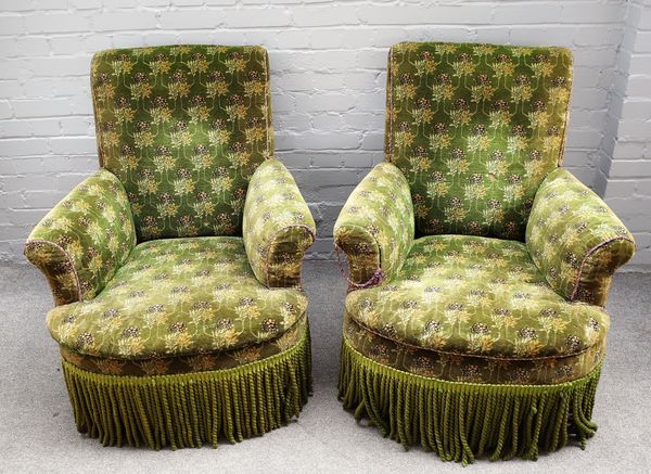 A pair of Victorian green upholstered armchairs, each with over-upholstered frame on turned tapering walnut feet and ware castors, 94cms high. (2)