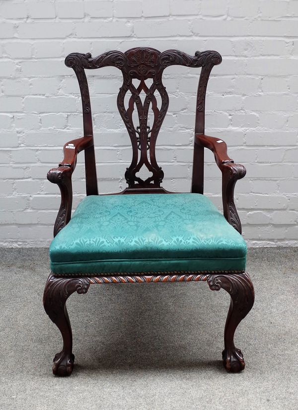 A mid-18th century style carved mahogany framed open armchair on claw and ball feet, 66cm wide x 97cm high.