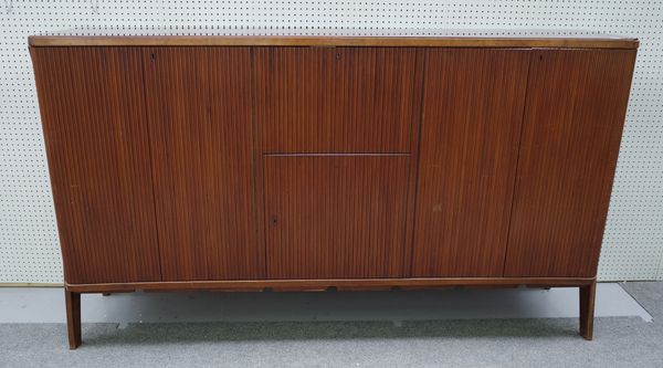 Osvaldo Borsani, (Italian, 1911-1985), a walnut credenza with red glass plate and concave front, 224cm wide x 130cm high.