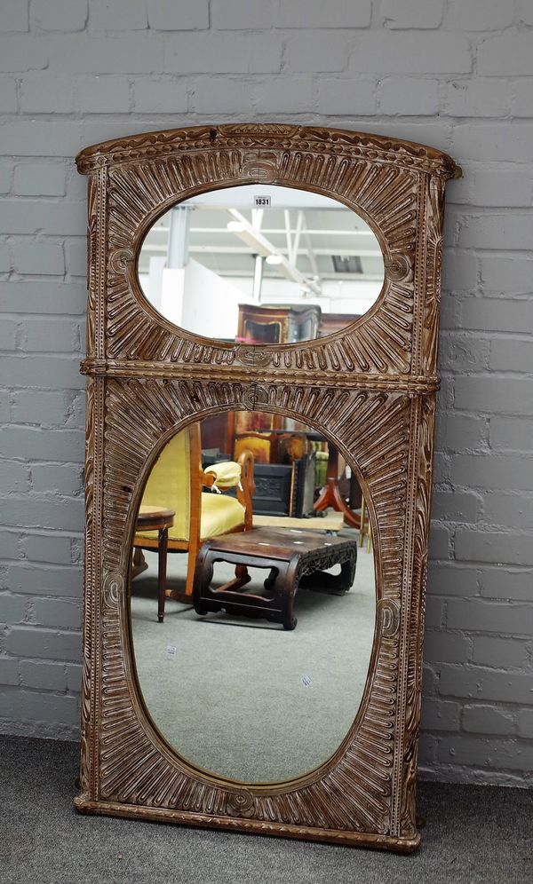 An Eastern limed wood twin plate tall mirror, carved gadrooned decoration, 72cms wide, 138cms high.