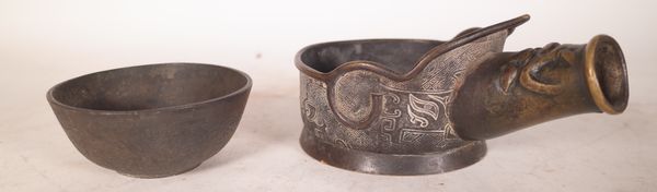 A Chinese bronze silk iron, probably 19th century, of traditional form, the sides decorated with taotie masks, 20cm. length; and a small bronze bowl w