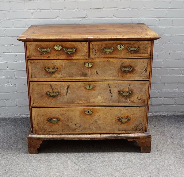 A George I crossbanded walnut chest of two short and three long graduated drawers, on bracket feet, 100cm wide x 94cm high.