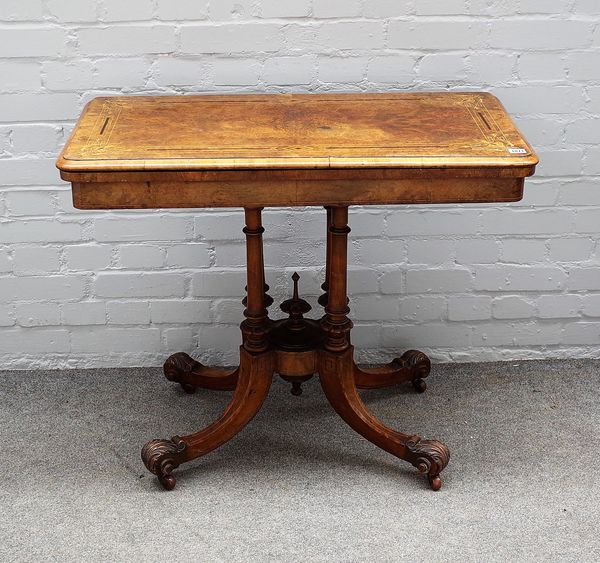 A Victorian inlaid figured walnut card table, with rounded rectangular top on four downswept supports, 92cm wide x 74cm high.