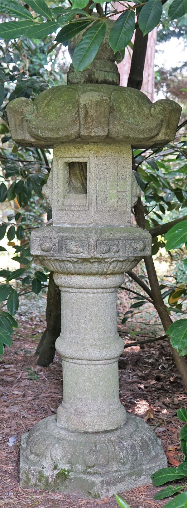 A Japanese carved stone garden lantern, 19th/20th century, on pedestal, 183cms high.