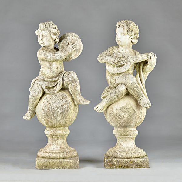 A set of three reconstituted stone figures of cherubs, each sat on a sphere playing a musical instrument, one a.f., each 100cm high. (3)  Illustrated