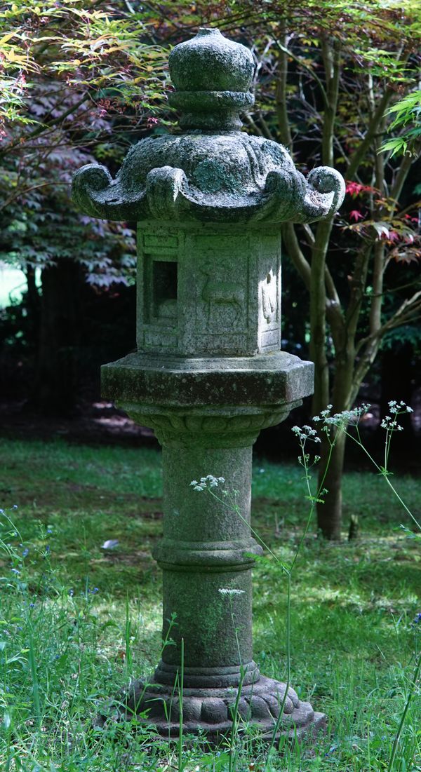 A Japanese carved stone garden lantern, 19th/20th century, on pedestal, 174cms high.