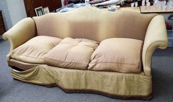 A mahogany sofa, with arched padded back and scrolled arms upon Regency ring-turned ribbed tapering legs and 20th century castors, 243cms wide, 102cms