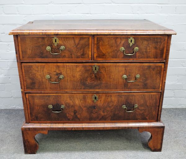 A George I inlaid figured walnut chest of two short and two long graduated drawers on bracket feet, 96cm wide x 86cm high.