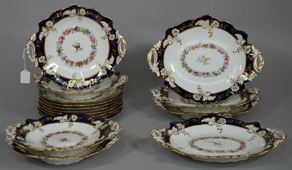 A Ridgway porcelain part dessert service, circa 1850, each piece decorated with a floral garland inside a deep blue and gilt foliate border, comprisin