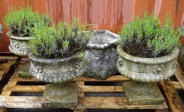 A set of three reconstituted stone jardinières on socles, 38cm diameter, together with a five sided jardinière, 48cm wide, (4).