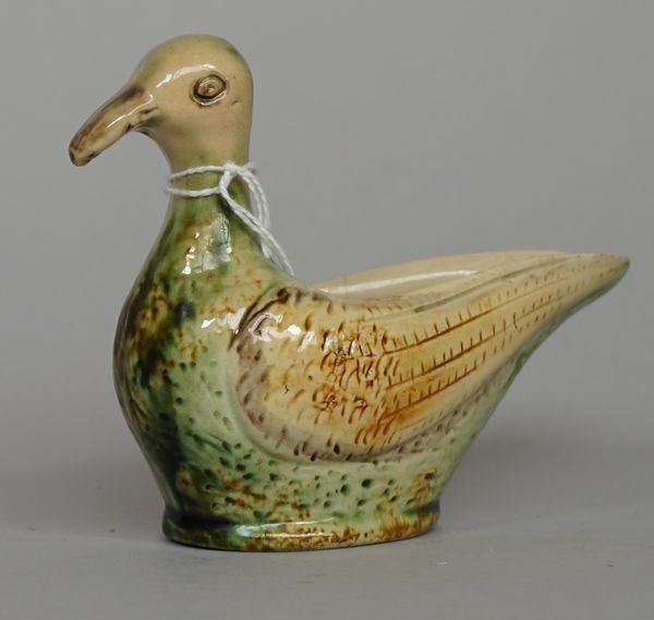 A Staffordshire earthenware duck sauceboat, late 18th century, washed in green and ochre glazes, 11.5cm. high.