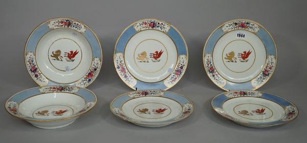 A Chamberlain-Worcester crested part dinner service, circa 1820, each piece painted in the centre with two crests beneath a blue border reserved with