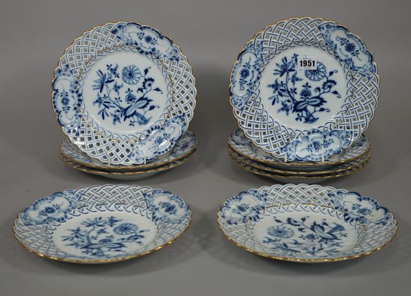 Nine Meissen blue and white plates, circa 1900 each decorated with the `Onion' pattern inside pierced borders, blue crossed swords marks, 23.5cm. diam