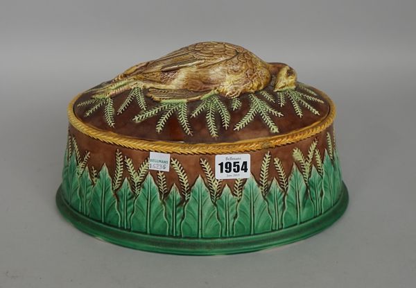 A George Jones majolica pie dish, the oval lid with dead partridge decoration, body with leaf molded banding, impressed seal mark to underside, circa.