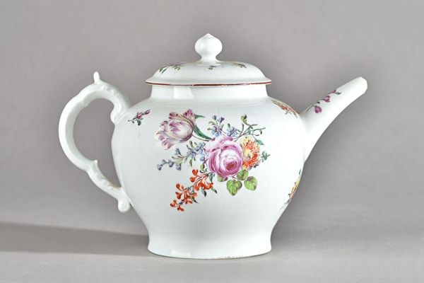 A Chelsea porcelain baluster teapot and cover, red anchor period, circa 1755 ,set with scroll moulded handle, painted with flower bouquets and sprigs,