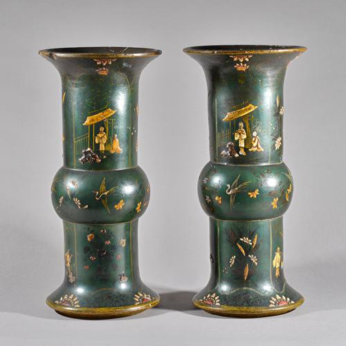 A pair of German faience green lacquered vases, probably Berlin, mid-19th century, of Chinese gu form, decorated in relief with panels of Chinese figu