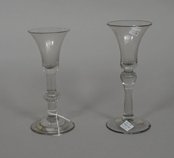 Two wine glasses, mid 18th century, the first with bell bowl with teared knop and domed foot, (a.f), 17cm. high; the second with bell bowl, raised on