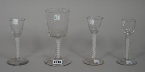 Four opaque twist wine glasses, circa 1765, comprising; a large glass with bucket bowl raised on a double series opaque twist stem, 17.5cm. high; two