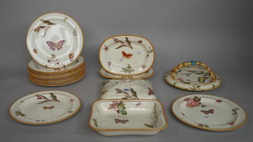 A Wedgwood pottery part dinner service, late 19th century, decorated with butterflies, insects and flowers within a yellow border, comprising; fourtee