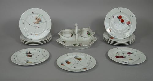 A set of twelve Christian Dior porcelain plates, each decorated with fruit and insects against a faux 'staple repairs' ground, 19.2cm diameter and a C