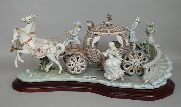 A Lladro porcelain centrepiece by J. Ruiz depicting Cinderella entering a horse drawn carriage, No 390, printed and painted marks to base, on a shaped