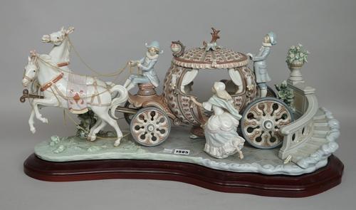 A Lladro porcelain centrepiece by J. Ruiz depicting Cinderella entering a horse drawn carriage, No 390, printed and painted marks to base, on a shaped