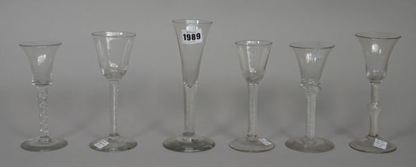 A group of six airtwist wine glasses, mid 18th century, various forms and sizes, (a.f), 15.25cm. to 19cm. high, (6).