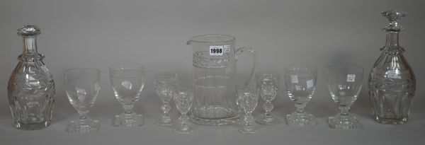 A William Yeoward glass table service with foliate engraved banding comprising; water jug, 20cm high, three decanters and stoppers, nine water glasses