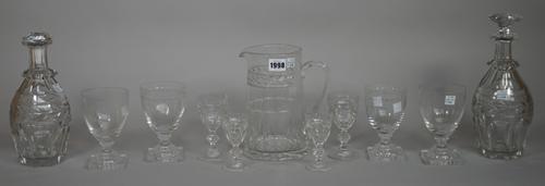 A William Yeoward glass table service with foliate engraved banding comprising; water jug, 20cm high, three decanters and stoppers, nine water glasses