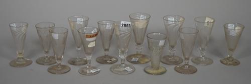 A group of thirteen dwarf ale glasses, 18th/early 19th century, some with wrythen moulded bowls, six engraved with hops and barley, 11cm. to 14cm. hig