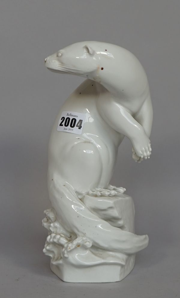 A Meissen white glazed porcelain otter, signed 'M.ESSER', blue crossed swords mark and further incised marks, 24cm high.